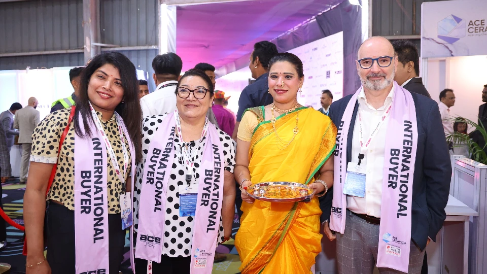 International buyers at Acetech Expo 2025, Bengaluru Building Expo Design Fair, posing with a traditionally dressed host.